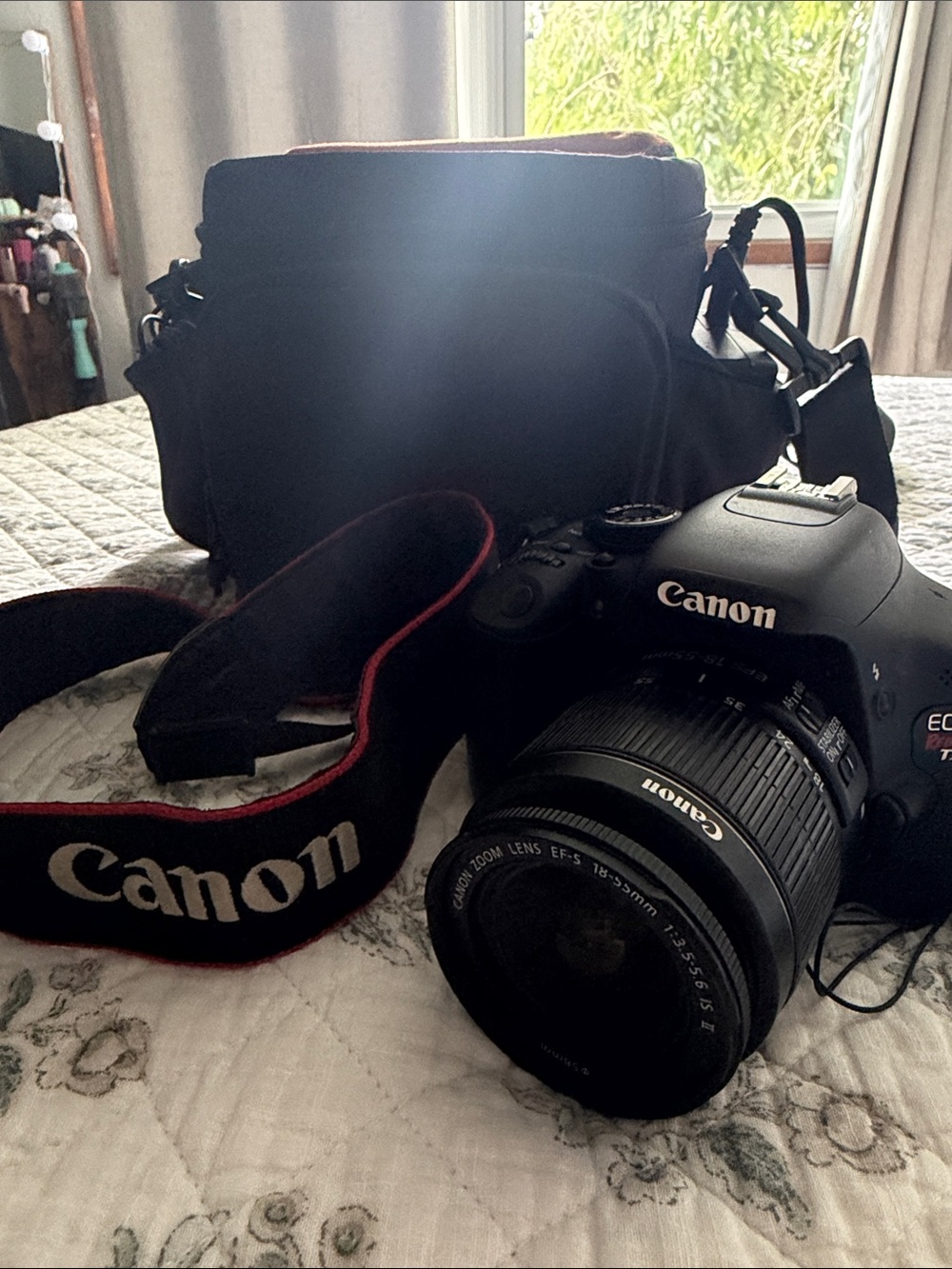 Canon DSLR Camera with Black Body and Red-Trim Strap